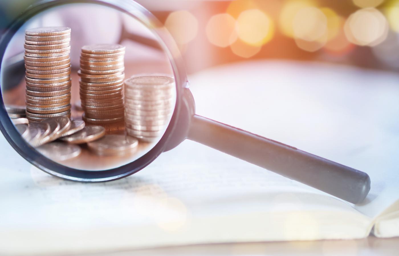 Image of magnifying glass and coins